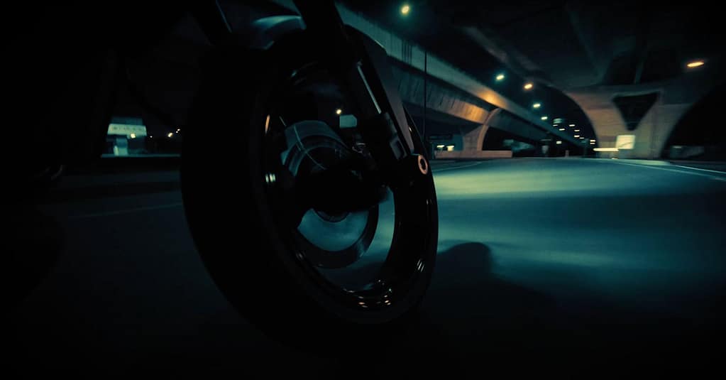 motorcycle front tire riding in the dark dramatic light