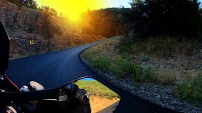 motorcycle riding a corner at sunrise