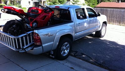 Load a motorcycle in the back of a truck